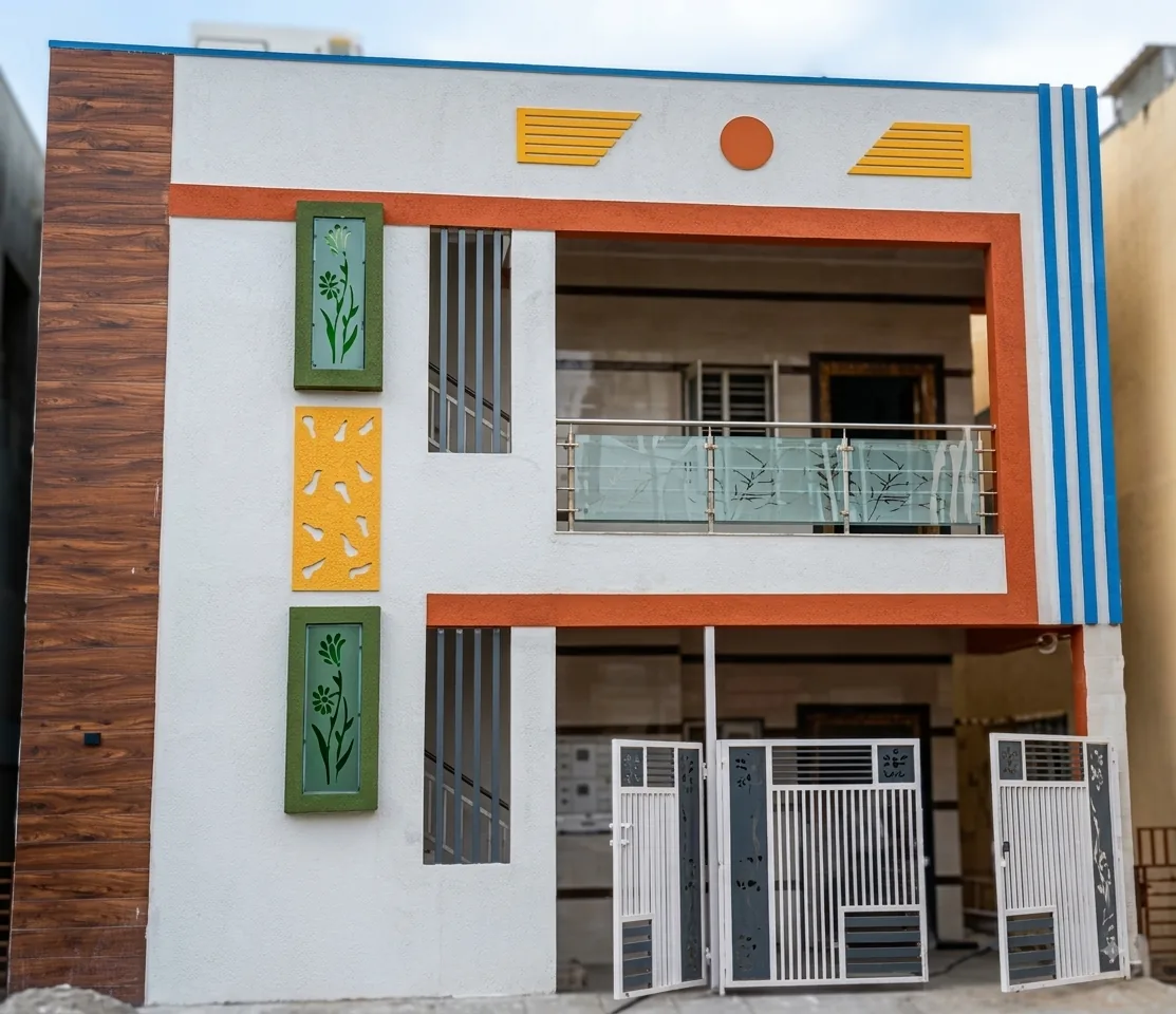 A completed two-storey independent house in Soladevanahalli with a wood-panelled accent wall and carved jaali screens on the façade.